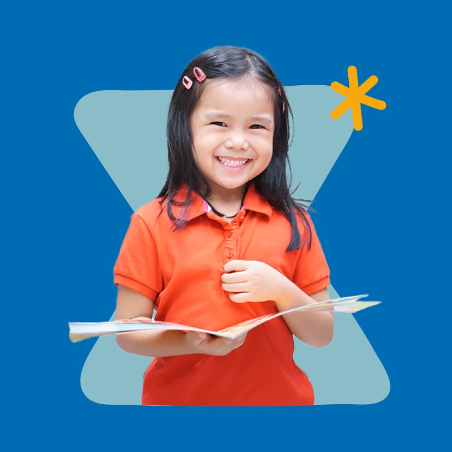 Young girl smiling and holding a book