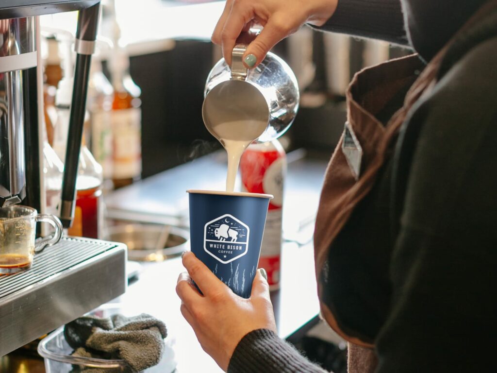 White Bison barista making a latte